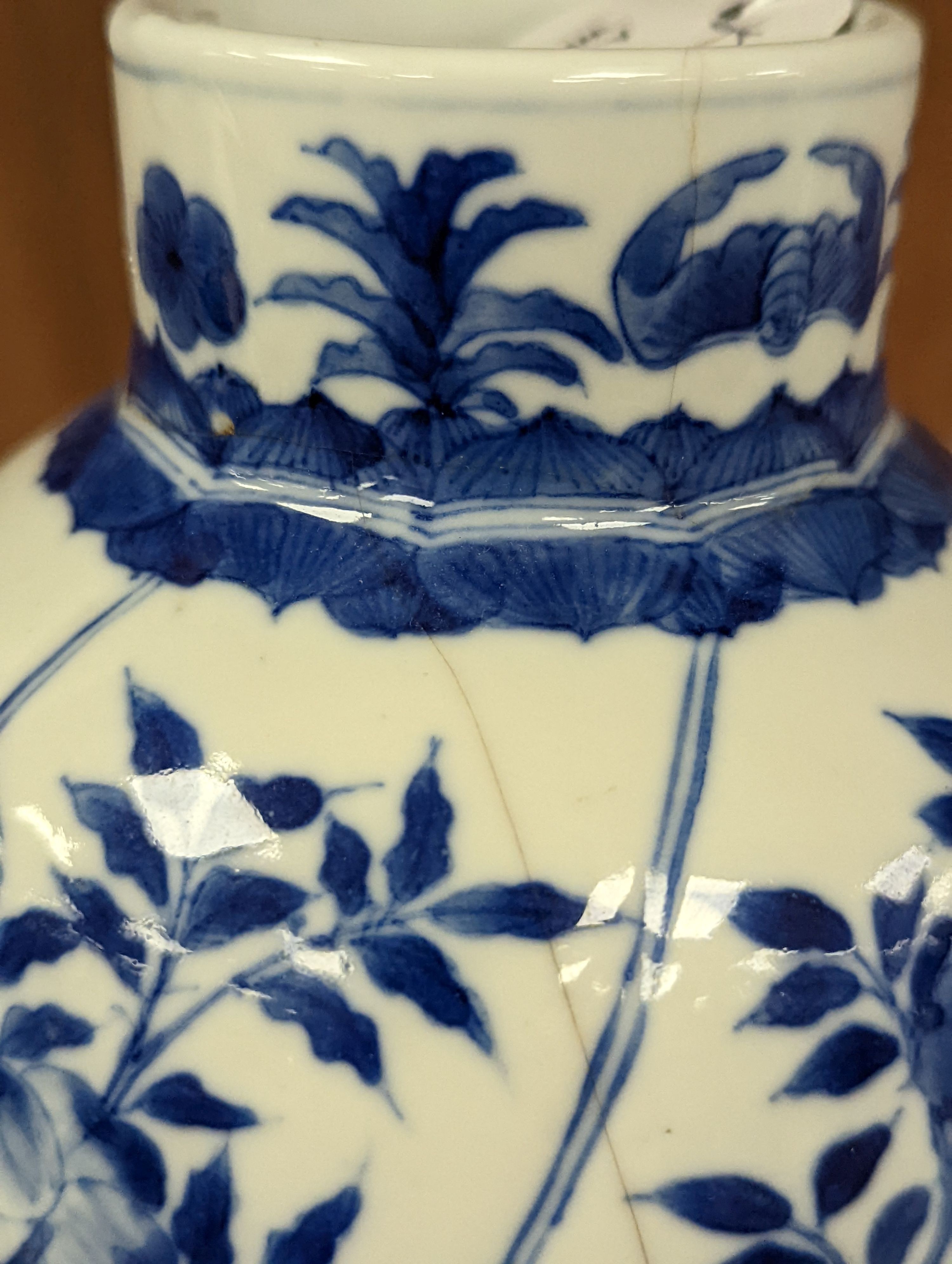 A Chinese blue and white vase and cover, Kangxi mark, 19th century, 26.5cm tall, and a Chinese Kangxi period small vase (2)